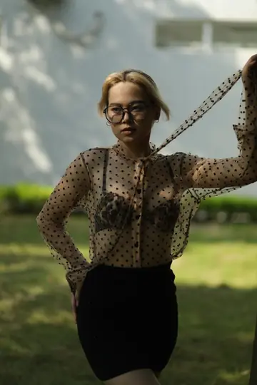 Asian Blonde in Glasses and Skirt Strips Outdoors
