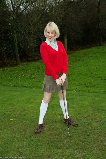 Hazel May – Mature Blonde in a Golf Uniform Spreads Her Hairy Pussy Outdoors