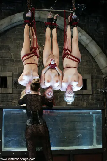 Jenny Lee – Busty Redhead MILF Bound in BDSM Restraints with Two Women