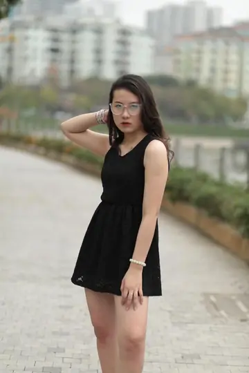Chinese Brunette in a Dress and Glasses Teases Her Feet Outdoors