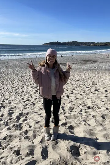 Slim Blonde in Glasses and Boots Spreads on the Beach