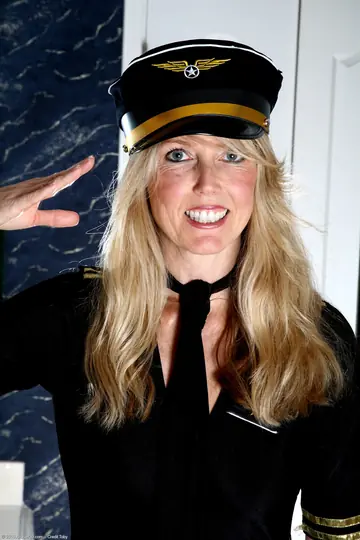 Redhead MILF in a Stewardess Uniform Spreads Her Trimmed Pussy