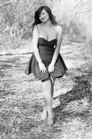 Carolina Rayne – Busty Brunette in a Dress and Heels Poses Among the Trees
