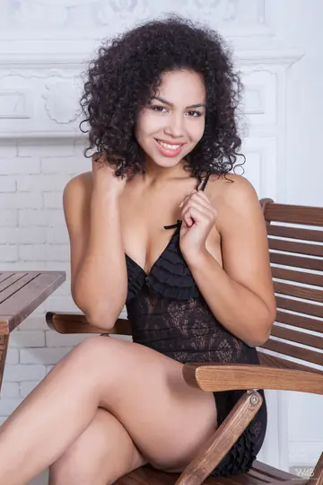Curly Ebony Woman Spreads Wide on a Chair