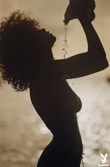 Tall Ebony Brunette with Big Tits Poses in a Bikini on the Beach