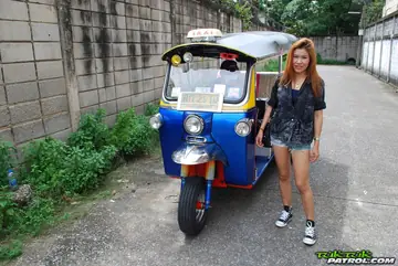 Noy – Thai Brunette Kisses Her Driver in a Mini Taxi Outdoors