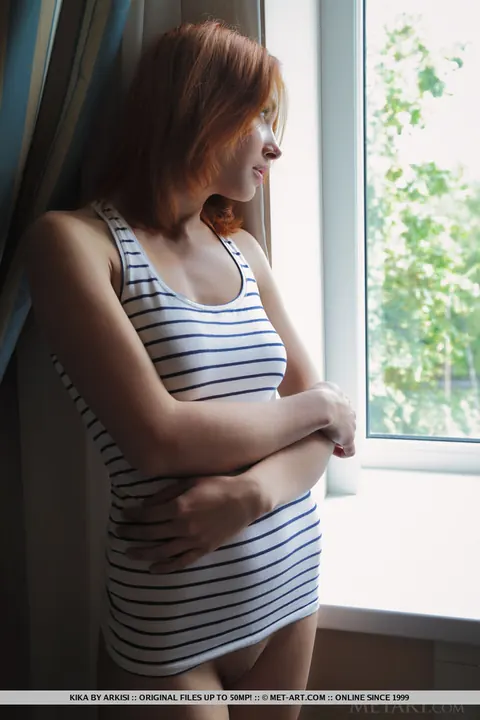 Calida: Petite Redhead Bares Her Big Tits by the Window – photo 17 of 18
