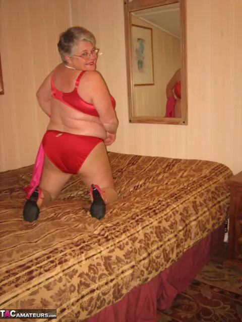 Silver-Haired Woman Pulls Down Her Pantyhose on the Bed – photo 11 of 20