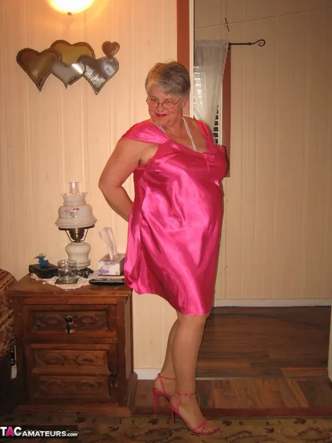 Silver-Haired Woman Pulls Down Her Pantyhose on the Bed – photo 1 of 20