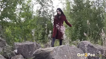 Woman in Boots Pulls Down Her Yoga Pants to Piss on Boulders
