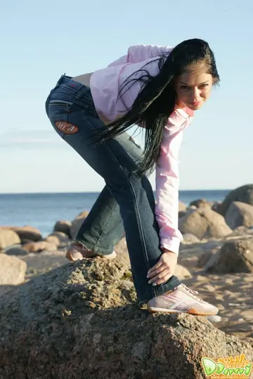 Brunette Strips Out of Her Jeans on the Beach