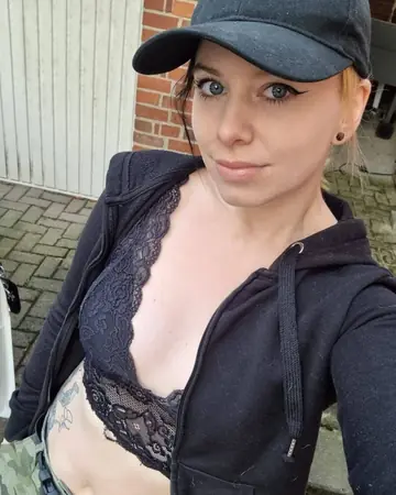 Blonde in a Bikini and Glasses Takes Selfies Outdoors
