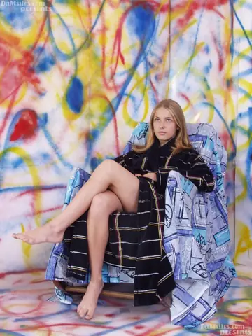 Skinny European Blonde Reveals Her Small Breasts on the Chair