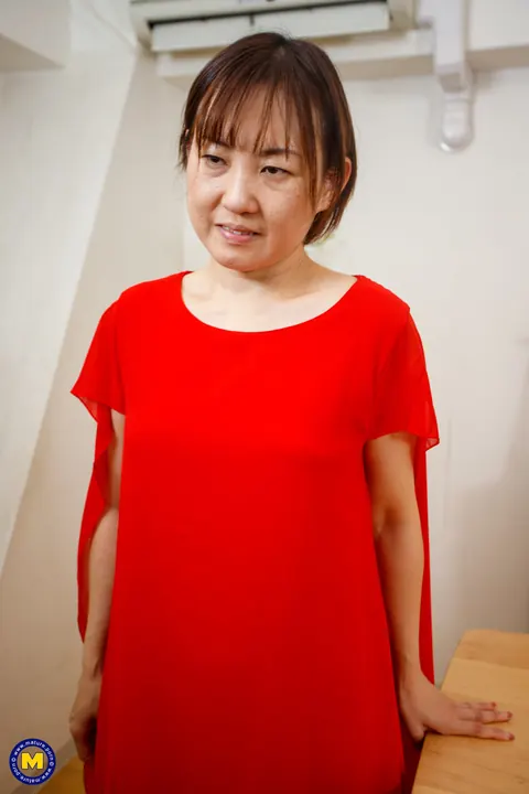 Yuki Kozakura: Mature Asian Woman Poses in a Red Dress and Flashes Her Panties – photo 11 of 20