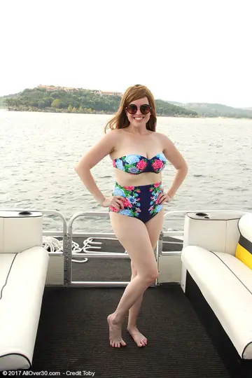 BBW Redhead in a Bikini and Glasses Flaunts Her Curves on a Boat