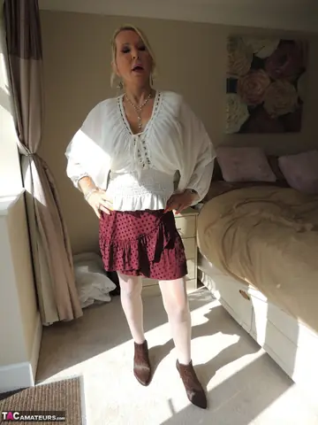 Blonde MILF Strips Off Her Skirt and Spreads Her Legs in Lingerie