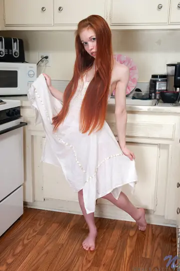 Petite Redhead Strips Off Her Skirt and Plays with Banana in the Kitchen