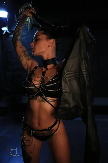 SunnyQ – European Brunette in Heels and Chains Poses Nude in a Dungeon