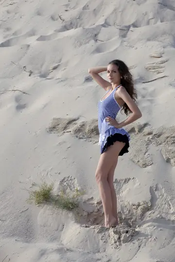Curly Brunette Poses Nude on the Beach