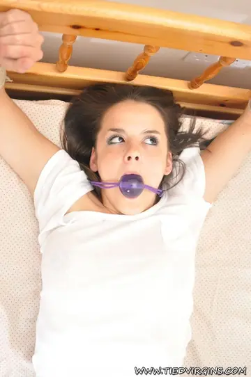 Petite Brunette Tied to Bed in Shorts with Ball Gag