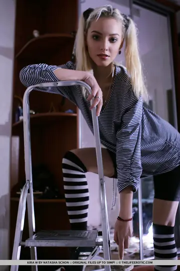 Kira W – Blonde Strips to Striped Socks and Shows Her Shaved Pussy