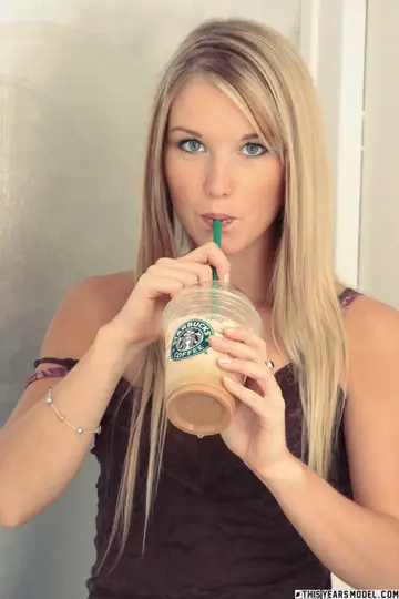 Blonde with a Piercing Undresses and Poses in Her Underwear
