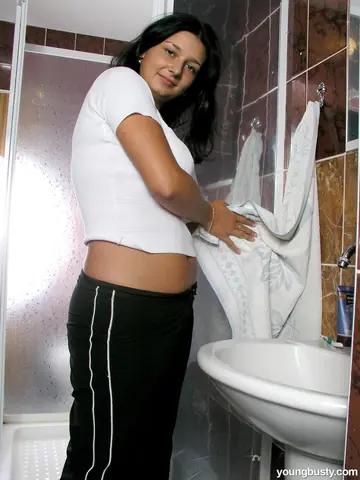 Thick Brunette Strips Out of Her Panties in the Bathroom