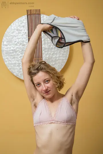 Slim Short-Haired Woman Undresses and Spreads Her Hairy Pussy