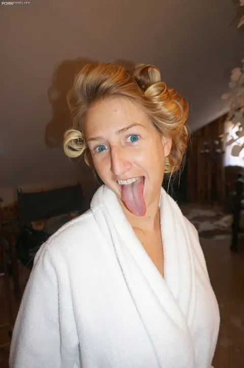 Brooke Banks: Thick Blonde with Big Enhanced Tits Poses in Stockings and Boots on the Bed – photo 17 of 17