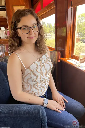 Petite Curly Brunette in a Dress and Glasses Spreads Her Shaved Pussy
