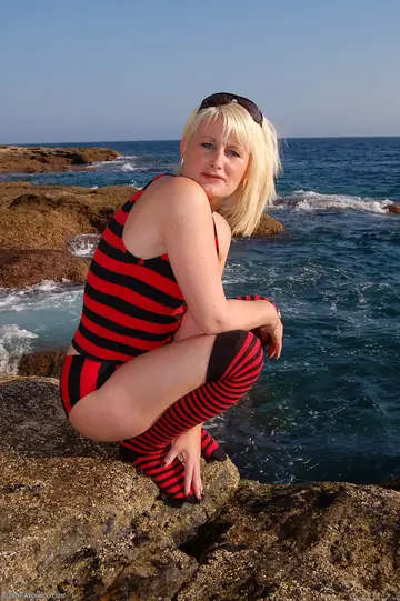 Short-Haired MILF Strips Out of Her Stockings on the Beach