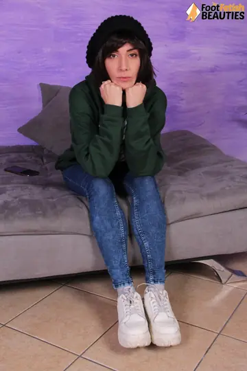 European Brunette Shows Her Feet in Jeans and Socks