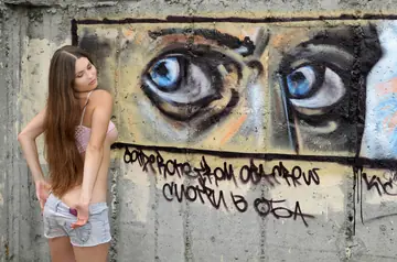 Busty Woman Strips Out of Her Shorts Outdoors in High Heels