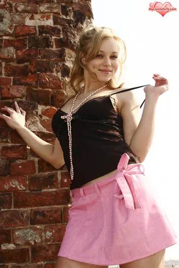 Blonde Lifts Her Skirt and Spreads Her Hairy Pussy by a Brick Wall