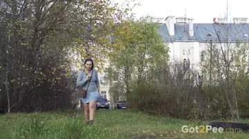 Woman in a Skirt and Pantyhose Pees on the Lawn