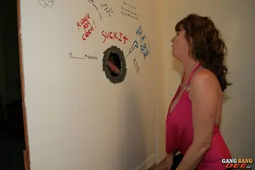Dee Delmar – Redhead MILF Sucks Cock Deep at the Gloryhole