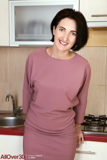 Slim Short-Haired MILF Lifts Her Skirt and Spreads in the Kitchen