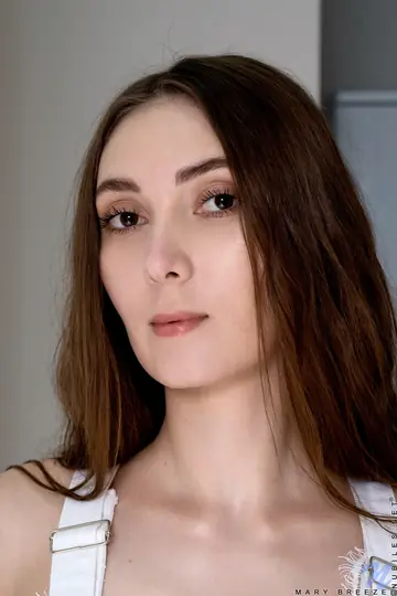Russian Brunette in a Bodysuit and Uniform Poses Nude