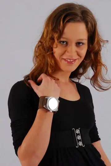 Redhead in a Skirt Over Jeans Poses with a Cuff Watch