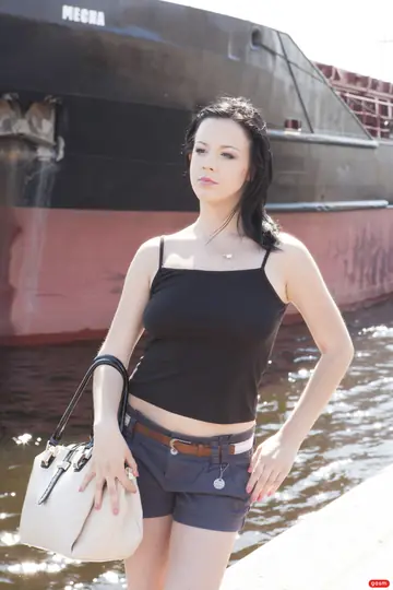 German Brunette Poses in Shorts and High Heels