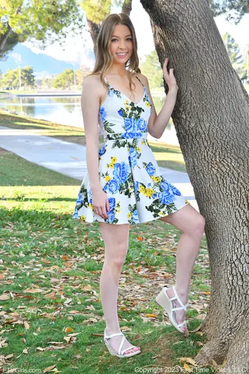 Woman Lifts Hem to Show Pink Panties on a Park Bench
