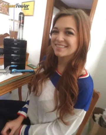 Redhead with Big Tits Poses in a Pleated Skirt