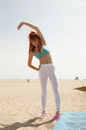 Penelope Lynn – Busty Tattooed Redhead Poses in Yoga Moves on the Beach
