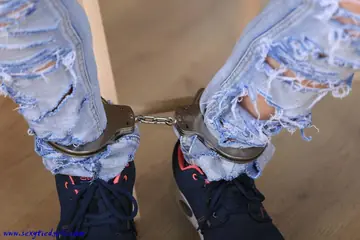 Woman in Ripped Jeans Ball-Gagged and Cuffed Spreads Her Legs