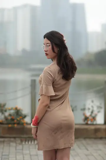 Asian Brunette Flashes Her Body in a Dress Outdoors