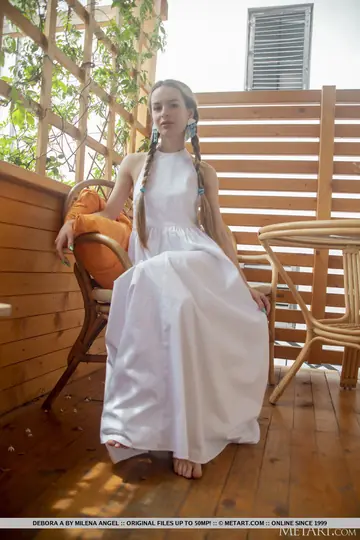 Debora A Kelly – Brunette in Braided Pigtails Lifts Her Skirt to Reveal Her Shaved Pussy
