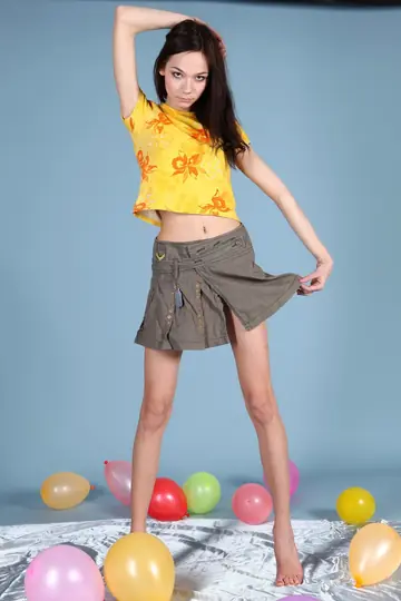 Mimi Yuliya – Tall Slim Brunette in a Skirt Flashes Her Shaved Pussy and Small Tits