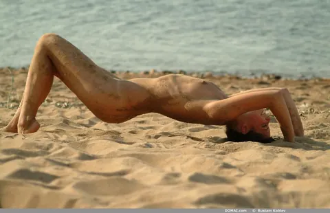 Slim Tanned Brunette Strips Nude on the Beach – photo 11 of 20