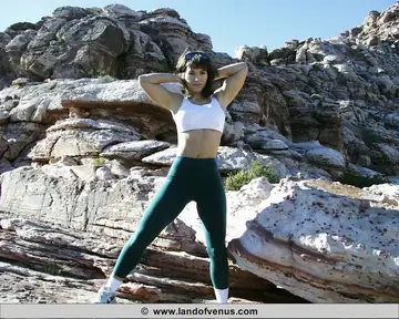 Thick Athletic Busty Babe Poses in Boots on Weathered Rocks