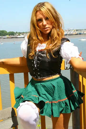 Busty Brunette in a Skirt and Heels Spreads Outdoors